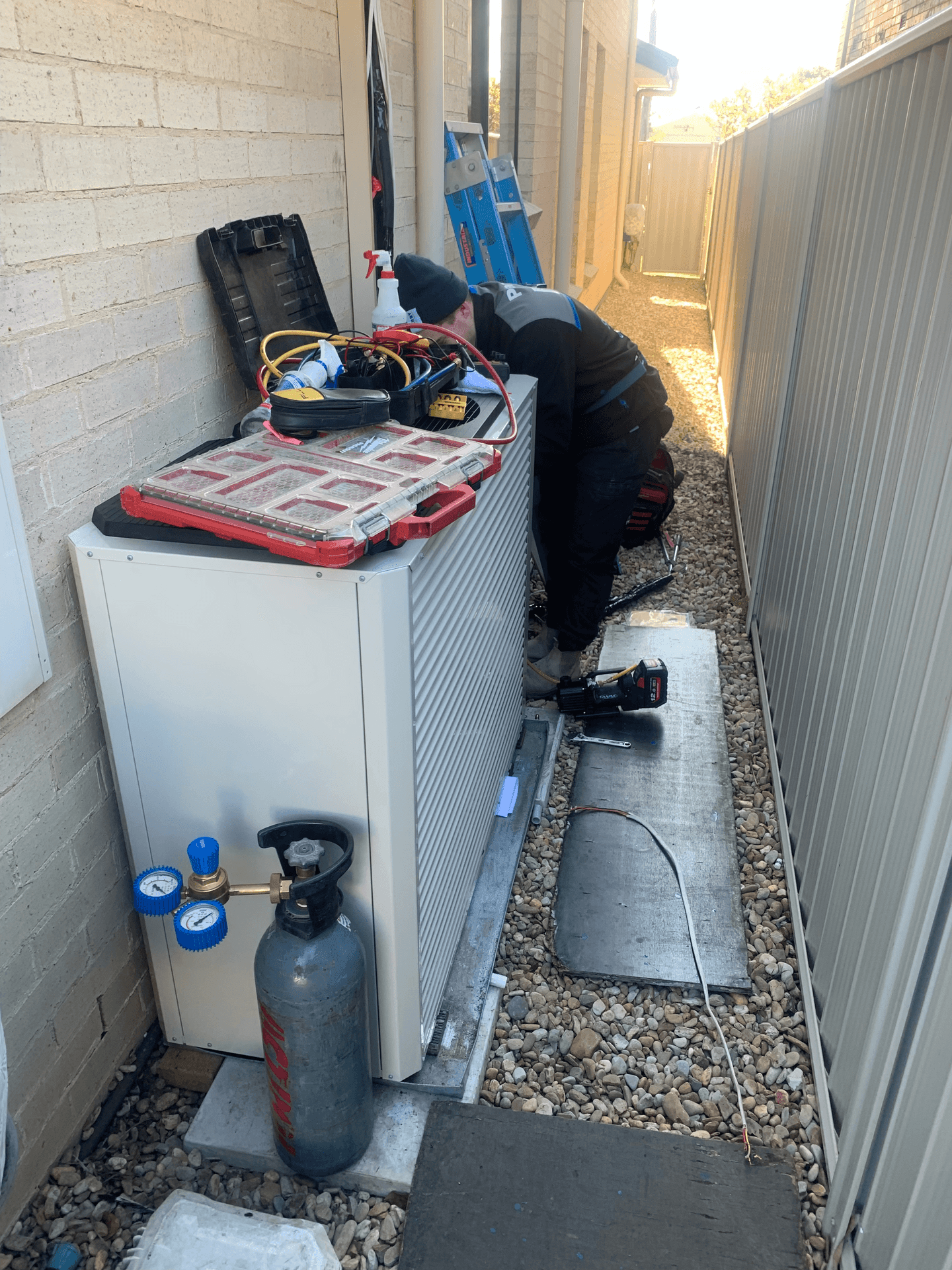 Seabreeze Air Conditioning technician repairs a faulty air conditioner at a house in Woonona