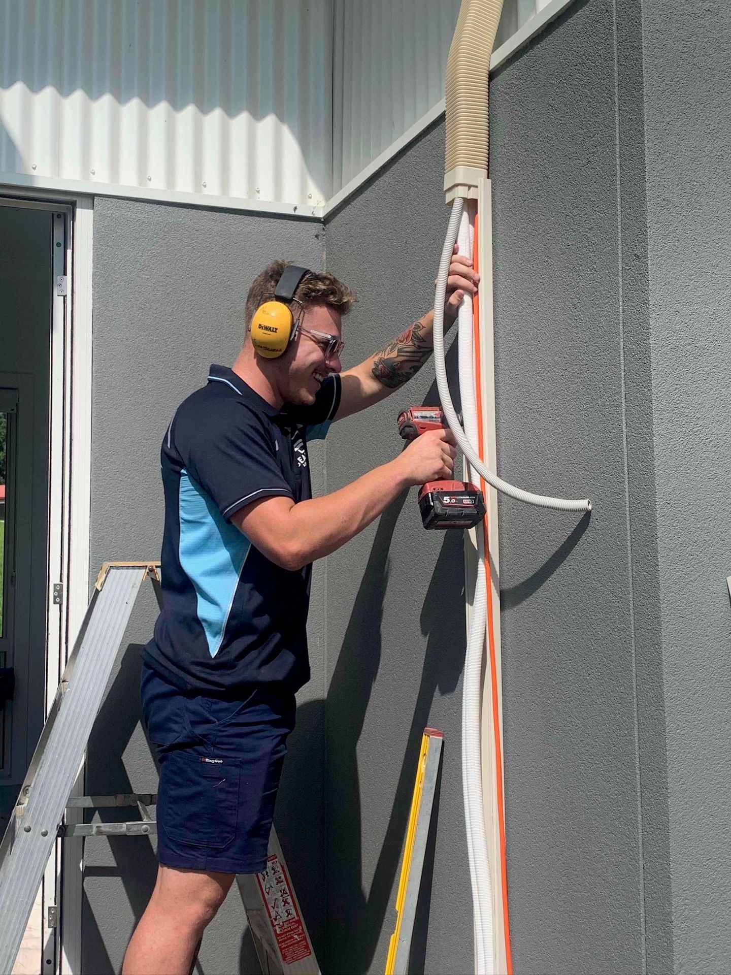 A technician from Seabreeze Air Conditioning completes a job in Wollongong