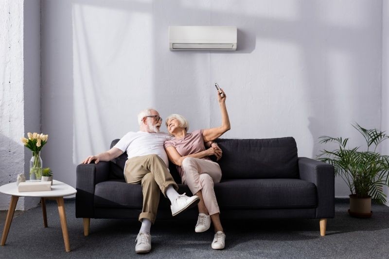 An older couple enjoys the comfort of their reverse cycle heating system