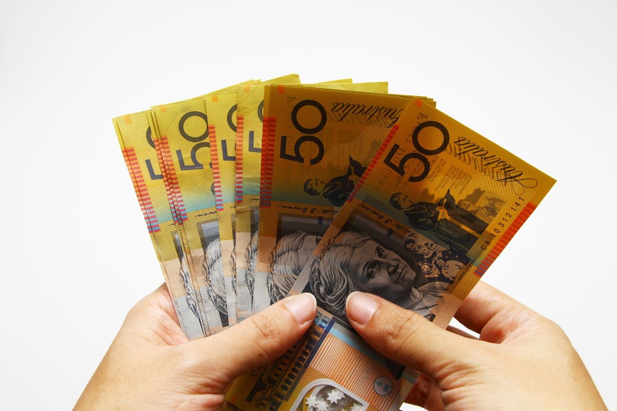 Australian dollar on white background / Australian dollar is also referred to as buck, dough, or the Aussie.